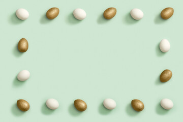 Decorated Easter golden and white eggs on green background. Happy Easter frame.