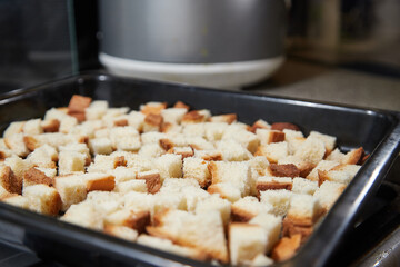 Square toasted pieces of homemade delicious rusk, hardtack, Dryasdust, zwieback on a baking sheet.