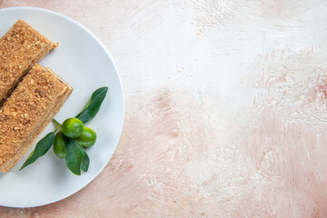 top view delicious cake slices honey cake on light desk cake biscuit pie sweet