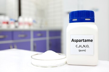 Selective focus of a bottle of pure aspartame artificial sweetener sugar substitute. White...