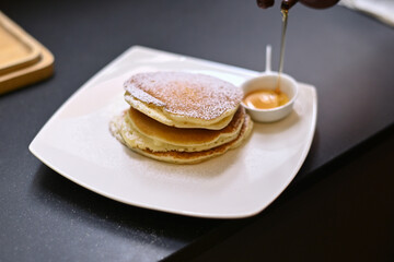 Fototapeta na wymiar pancakes breakfast with bananas on white dish