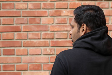 casual Young man Standing back showing half face and thinking    in the Outdoor