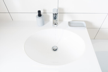 Modern bathroom at home. White stone table in bathroom and new mixer