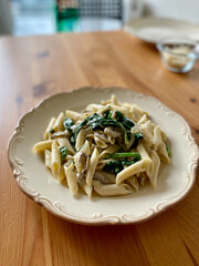 Penne Pasta with Baby Spinach and Truffle Cream Sauce. Served with Parmesan Cheese.