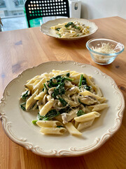 Penne Pasta with Baby Spinach and Truffle Cream Sauce. Served with Parmesan Cheese.