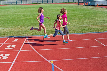 Family fitness, mother and kids running on stadium track, training and children sport healthy...