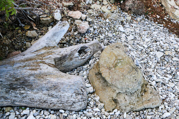 mountain textures of stones with interlayers of gypsum, colored quartz, clay, sand and other layers of various ores, with different textures, color and density, in gypsum ore quarry.