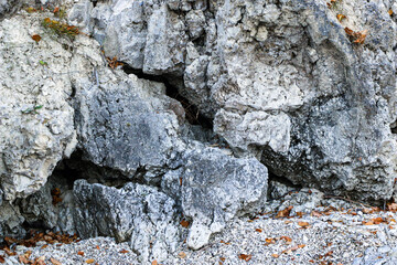 mountain textures of stones with interlayers of gypsum, colored quartz, clay, sand and other layers of various ores, with different textures, color and density, in gypsum ore quarry.