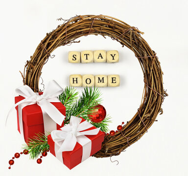 Christmas arrangement with rottan wreath, holiday decorations and Lettering STAY HOME on white