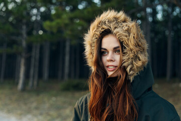 Woman in hooded jacket attractive look nature lifestyle cropped view