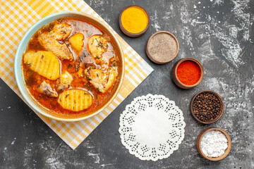 Above view of homemade soup with chicken spices set and decorative napkin
