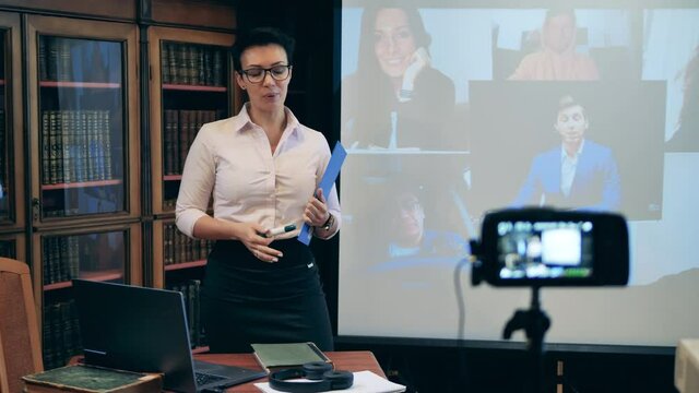 Teacher showing basic geometric shapes to remote students