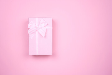 Gift rectangular pink box with bow on a pure pink background