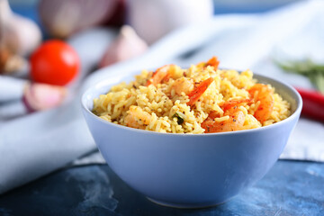 Bowl with tasty pilaf on table