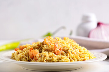 Plate with tasty pilaf on table