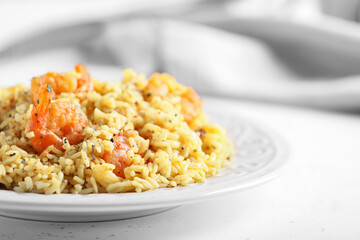 Plate with tasty pilaf on table