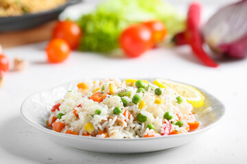 Plate with tasty pilaf on table