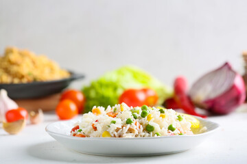 Plate with tasty pilaf on table