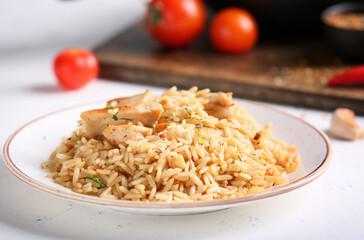 Plate with tasty pilaf on table