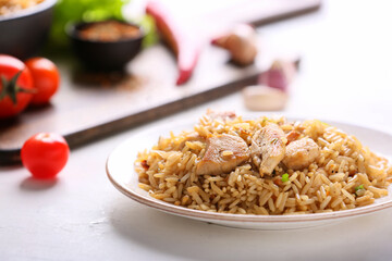Plate with tasty pilaf on table