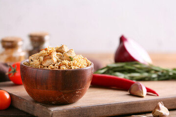 Bowl with tasty pilaf on table