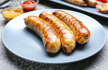 Plate with delicious grilled sausages, closeup