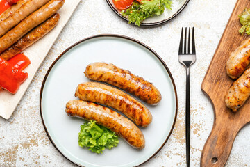 Plate with delicious grilled sausages and vegetables on wooden table