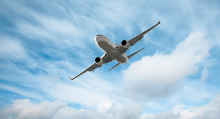 White passenger airplane over the clouds  - Travel by air transport