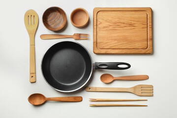 Different wooden dishes on white background, top view