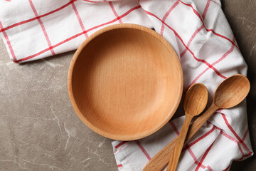 Kitchen napkin with wooden dishes on gray table