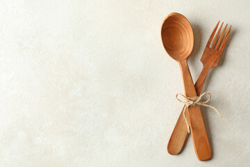 Wooden spoon and fork on white background, space for text