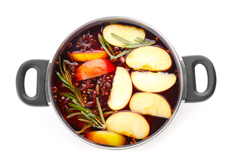 Saucepan with hot mulled wine on white background