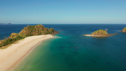 Tropical island with sandy beach, aerial view. Nacpan, El Nido, Palawan, Philippine Islands. Seascape with tropical beach and islands. Summer and travel vacation concept