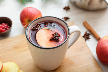 Cup of hot mulled wine on table