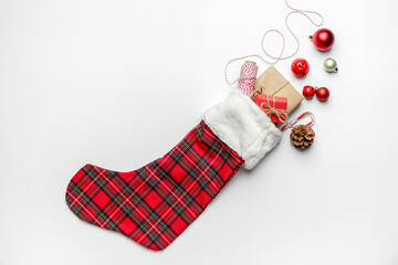 Composition with Christmas sock on white background