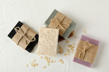Different natural handmade soap on white table