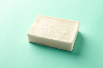 Piece of natural handmade soap on mint background