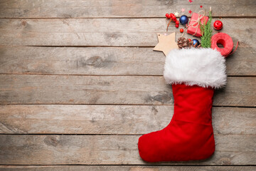 Composition with Christmas sock on wooden background