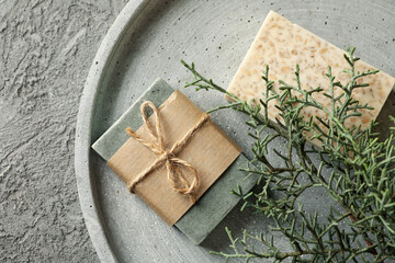 Tray with natural handmade soap on gray background