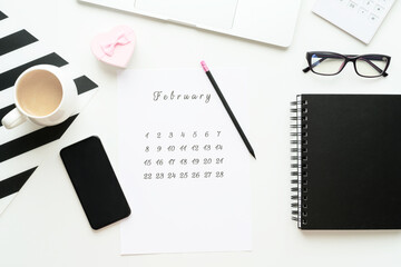 14 February calendar on work space with pink gift heart Valentine's Day card, cup of cofe, Flatlay