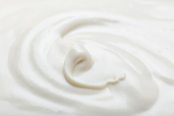 Fototapeta na wymiar Liquid white chocolate on white background