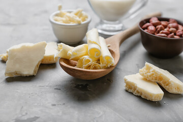 Spoon with white chocolate on grunge background