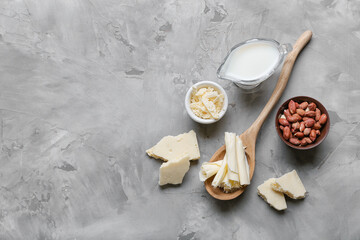 White chocolate with milk and nuts on grunge background