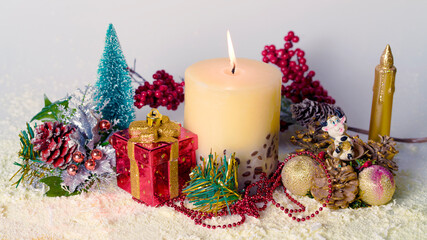 Christmas composition with candle, decorations and toy bull symbol of the year