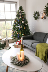 Burning candles in interior of living room decorated for Christmas