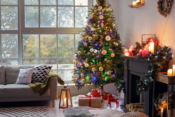 Beautiful Christmas tree and boxes with presents near fireplace