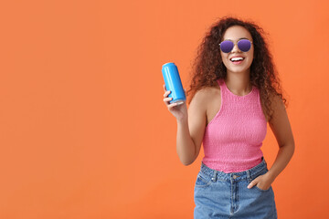 Beautiful African-American woman with soda on color background