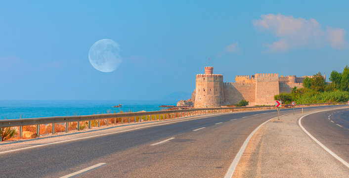 Amazing Mamure Castle with 
  Full Moon, asphalt road in the foreground - Anamur Turkey "Elements of this image furnished by NASA"