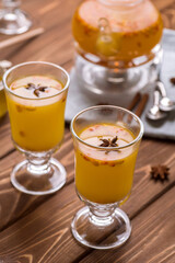 Beautiful glass teapot with orange sea buckthorn tea. Hot winter drinks,