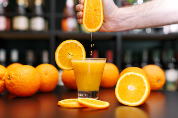 Glass of orange juice and oranges